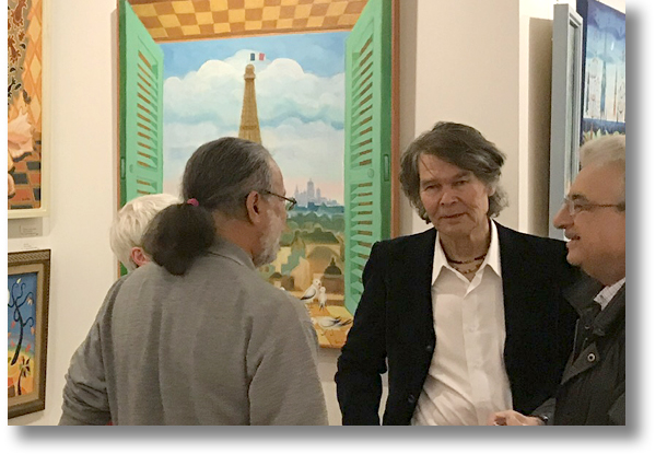Sami in a gallery with his paintings